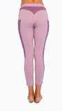 Purple leggings with a high waistband on a white background