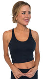 Woman wearing a black sports bra and leggings on a white background