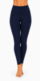 A person modeling a pair of high-waisted navy blue leggings against a plain white studio background.