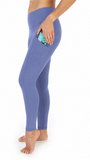 A person wearing high-waisted periwinkle blue leggings with a side pocket holding a phone, shown from the waist down against a plain white background.
